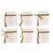 Hello Honey® 8.5" White & Red 6-Piece Wood Block Faux Books with Holiday Saying, Wood Beads & Jute Tie